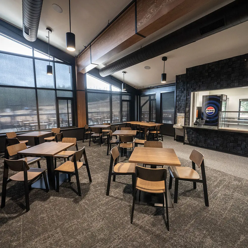 caribou cafe has tables and chairs and a small food window